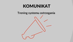 Grafika przedstawia megafon. Na Grafice widnieje napis "KOMUNIKAT - Trening systemu ostrzegania".