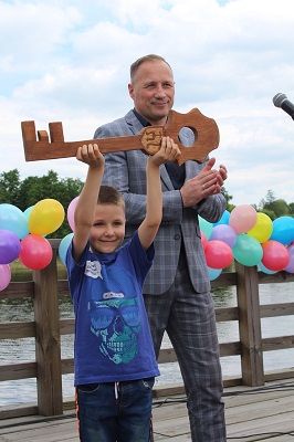 Na zdjęciu widoczny Burmistrz Szydłowca Artur Ludew przekazujący klucz do miasta na ręce delegacji dzieci.